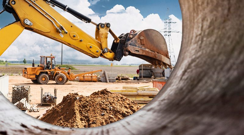 9 Emerging Trends in Construction Equipment: 2024 Outlook Image of a view through a cement mixer middle showing different construction machinery on a building site to support construction equipment article